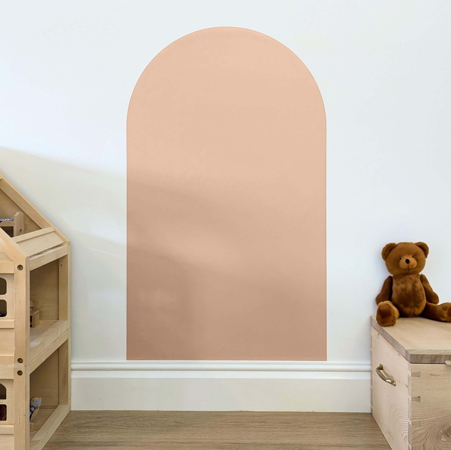 Blush pink coloured arch shaped children's magnetic wall decal on a white wall
