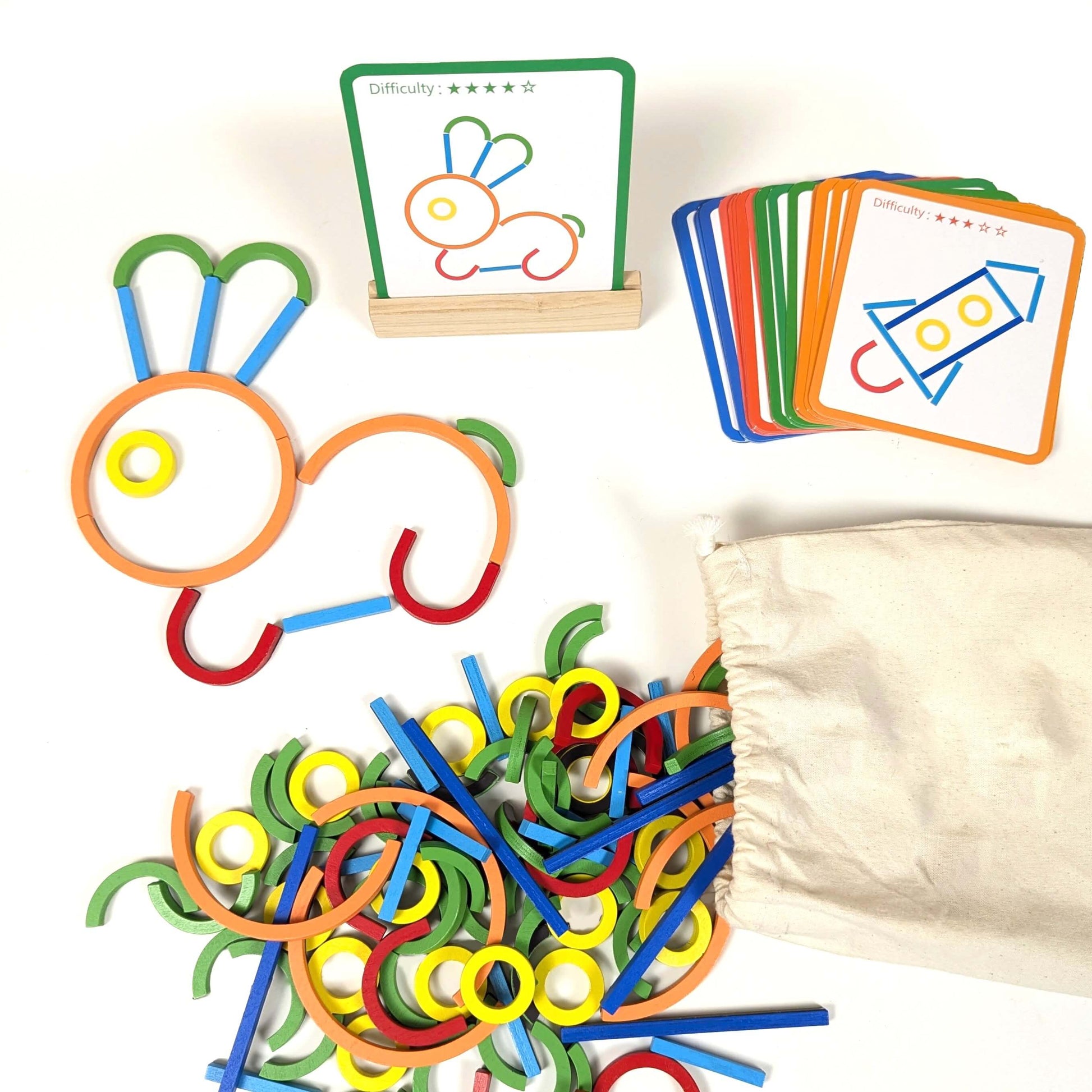 a set of wooden magnetic sticks and rings shapes, with picture cards, a wooden card holder and a cotton storage bag.