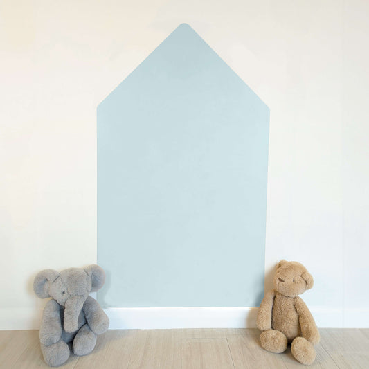 Blank light blue house shaped wall decal on a white wall with two teddies sat infront