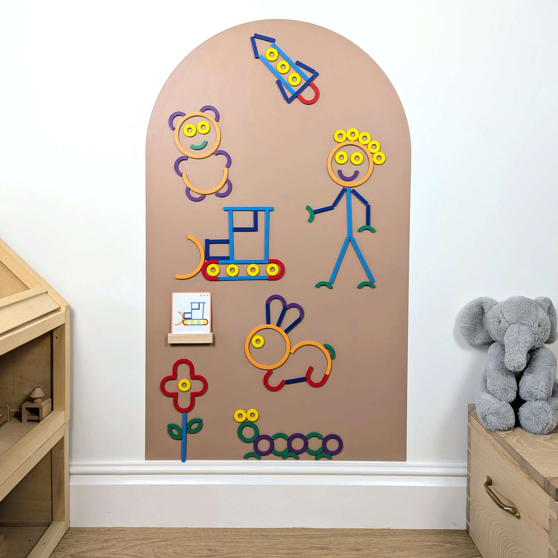 Lots of colourful wooden magnetic shapes in the shape of animals and other objects on wall decal